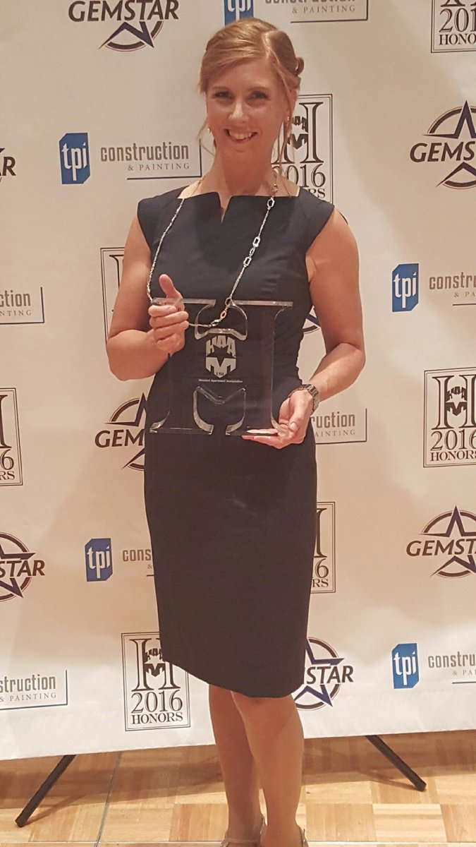 Kylie Schischka receiving a National Apartment Association award